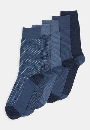 Set of five blue socks featuring various designs: polka dots, herringbone, stripes, and solid textures. Blended fabric with ribbed cuffs.