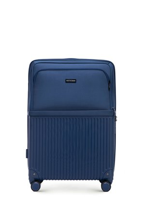 Valise rigide bleu marine avec des rainures verticales, roues doubles, compartiments zippés et une poche avant. Logo de la marque visible à l'avant.