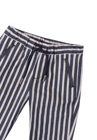 Pantaloni lounge a righe blu navy con linee bianche e beige. Presentano una vita elastica, un cordino e due tasche laterali.