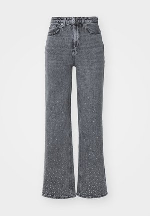 Jeans a zampa d'elefante in denim grigio con vita alta, caratterizzati da un sottile motivo a pois e design a cinque tasche. Texture usurata vicino all'orlo.