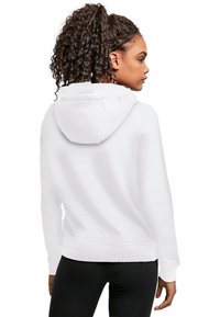 Hoodie bianco in cotone con cappuccio regolabile, maniche lunghe e orlo a coste, mostrato dal retro, abbinato a leggins neri.