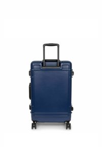 Navy hard-shell suitcase with a telescopic handle and four wheels, featuring a smooth texture and minimalistic design.