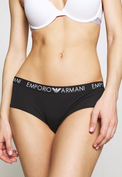 Black Emporio Armani briefs with a wide elastic waistband featuring white logo text. Smooth fabric, mid-rise cut, and no visible patterns.