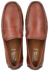 Brown leather loafers with a smooth texture, rounded toe, and a subtle stitch detail. Features branding label inside and a flexible sole.