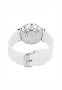 White silicone watch strap with stainless steel hardware. Round silver case with a glass back. Features a metal clasp and engraved logo.