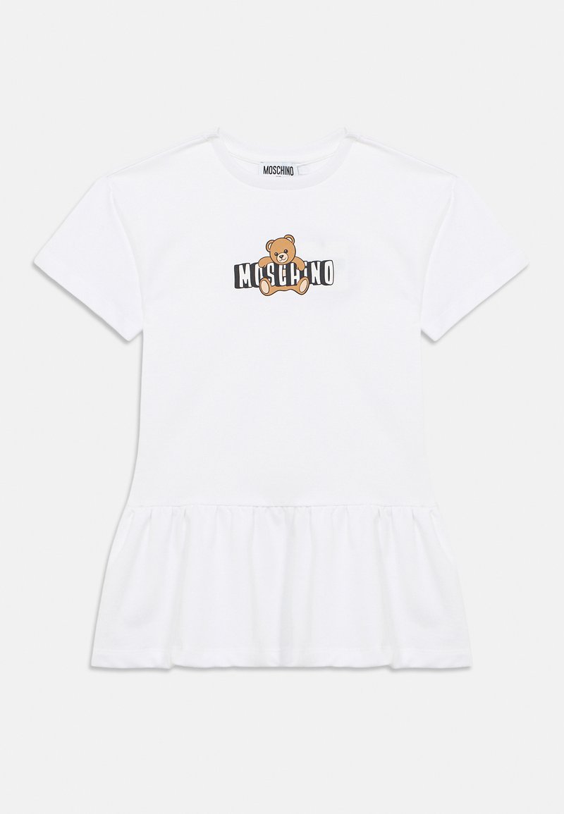 Λευκό βαμβακερό μπλουζάκι με βολάν στο τελείωμα. Διαθέτει γραφικό με αρκουδάκι και κείμενο "MOSCHINO" σε μαύρο και πορτοκαλί χρώμα στο μπροστινό μέρος. Κοντά μανίκια.
