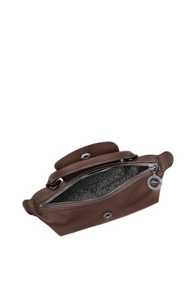 Brown leather clutch purse with zipper open, showing patterned fabric interior and silver zipper pull with brand logo.