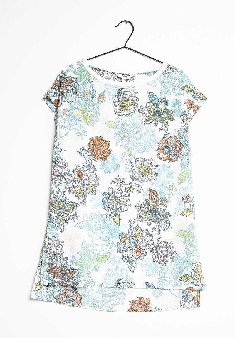 Short-sleeve floral tunic in white, featuring blue, orange, and green flower patterns. Material appears smooth with a slight sheen.