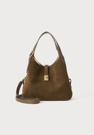 Brown suede handbag with a rounded shape, a detachable shoulder strap, leather accents, and a gold square hardware detail at the front.