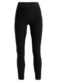 Svarta högmidjade leggings med framfickor, slim fit och ankle-length design på vit bakgrund.