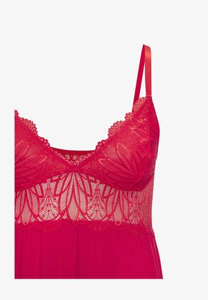 Punane pitsist rinnahoidja lillemustriga, läbipaistev detail ja reguleeritavad satiinstrapid. Sile materjal allosas ja vohavad siluett.