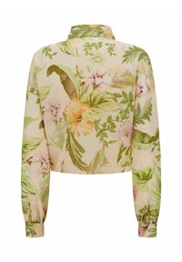 Blouse courte en tissu beige léger présentant un motif floral avec des feuilles vertes et des fleurs roses/oranges. Manches longues avec poignets boutonnés.