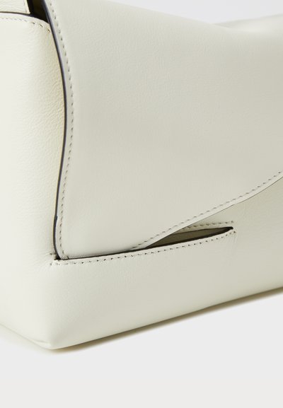 Light beige leather bag with a smooth texture, angled shape, and subtle stitching details. Features a small side opening for accessibility.