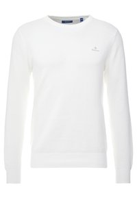 Weißer Strickpullover mit rundem Hals, langen Ärmeln und strukturiertem Muster. Verfügt über ein kleines graues Logo auf der Brust.