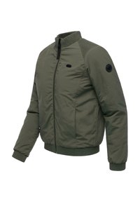Veste bomber vert olive avec col et poignets côtelés, dotée d'une fermeture éclair frontale et d'un patch décoratif sur le côté. Texture lisse, matériau léger.
