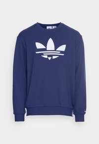 Granatowa bluza wykonana z mieszanki bawełny, z dużym białym logo trefoil Adidas i paskami na piersi, z prążkowanymi mankietami.