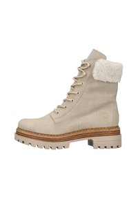 Bottines beiges avec un revers en fourrure douce, design à lacets, dessus en cuir texturé et semelle robuste à motifs. La semelle intermédiaire empilée ajoute du caractère.