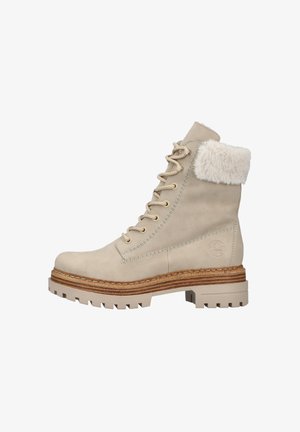 Stivale alla caviglia beige con risvolto in morbido pelliccia, design con lacci, tomaia in pelle texturizzata e suola robusta e decorata. Il fondello impilato aggiunge un tocco di carattere.