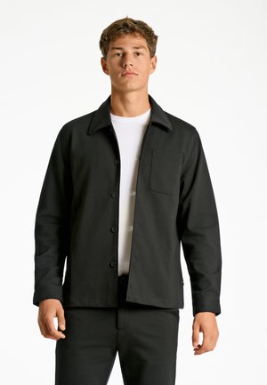 Black lightweight button-up jacket with a collared neckline, chest pocket, and a smooth texture, paired with matching pants.