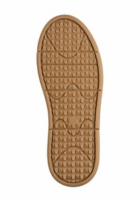 Gummisohle in Beige mit strukturierter Oberfläche, die wellenförmige Muster und kreisförmige Akzente für besseren Halt aufweist. Abgerundete Zehenpartie und robuste Bauweise.