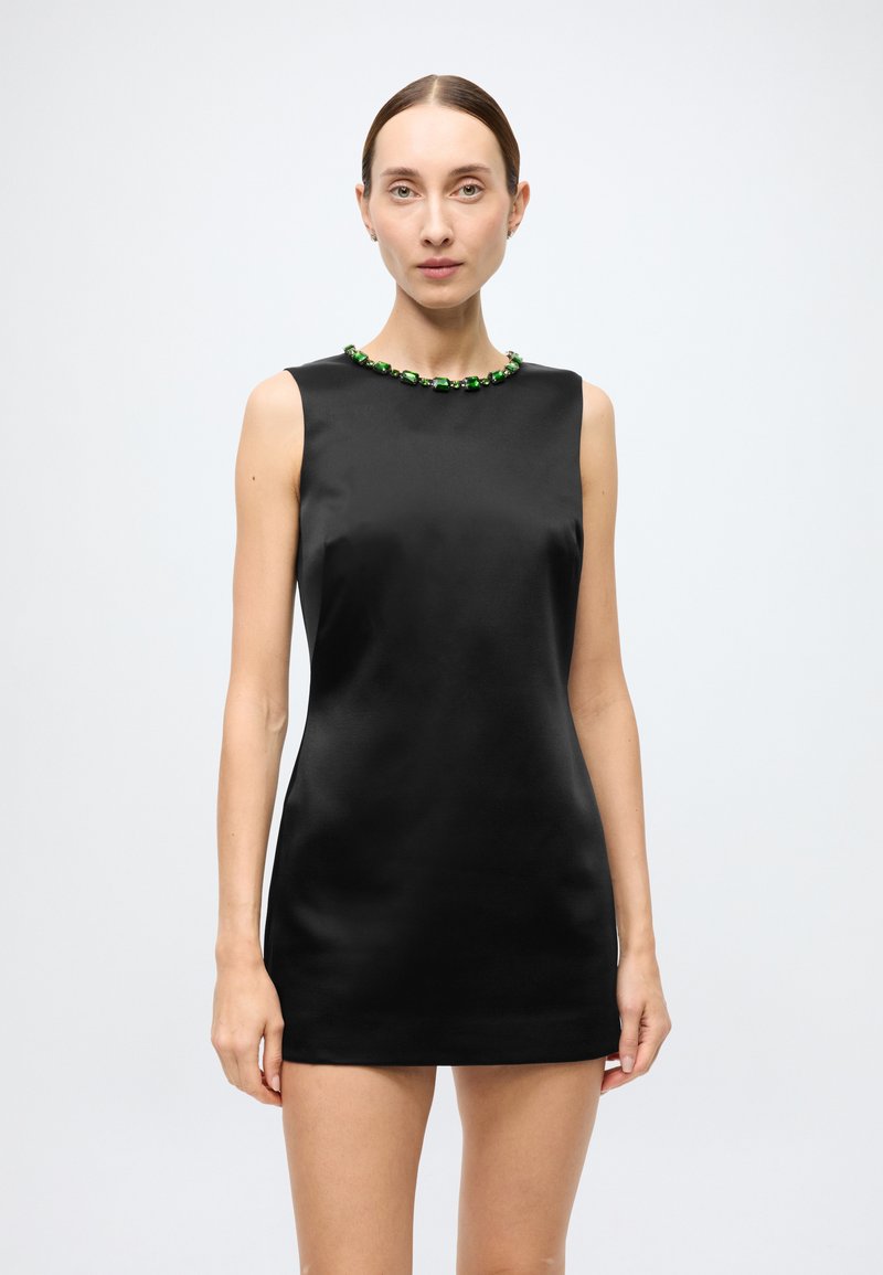 Black satin sleeveless dress with a fitted silhouette, featuring a green beaded neckline. Smooth texture and minimalistic design.