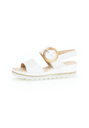 White leather sandal with open toe and a wide strap. Features a large wooden accent buckle and a wedge sole with a textured bottom.