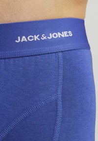 Blue cotton blend boxer briefs with an elastic waistband featuring "JACK & JONES" logo in white, smooth texture and fitted design.