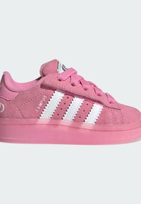 Pink suede sneaker with a translucent pink sole, featuring white three stripes and matching shoelaces, designed for casual wear.