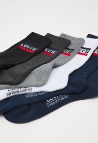 Six pairs of cotton socks in black, gray, navy, and white with ribbed texture and "Levi's" label featuring red and navy accents.