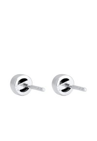 Boucles d'oreilles clou en argent sterling avec une forme ronde plate, finition polie et poinçon 925, présentant un tige droite pour un maintien sécurisé.