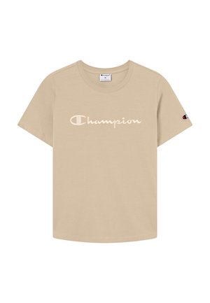 Beżowa koszulka Champion z krótkimi rękawami, okrągłym dekoltem, z napisem "Champion" na środku przodu oraz naszywką z logo na lewym rękawie.