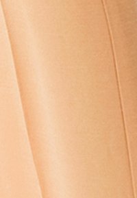 Beige fabric with a smooth texture and slight sheen, featuring a soft drape and gentle folds, showcasing neutral tones without patterns or accents.