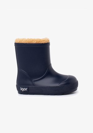 Botte en caoutchouc marine avec une semelle à grip texturée, ornée d'une garniture en fausse fourrure beige sur le haut et d'un logo en relief sur le côté.