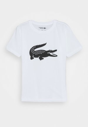 T-shirt en coton blanc présentant un graphisme de crocodile noir avec des motifs triangulaires le long de son dos. Col rond ; manches courtes.