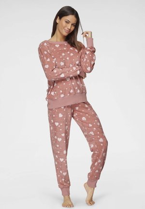 Rosa Fleece-Pyjama-Set mit verstreuten weißen Herzmustern, langen Ärmeln, gerippten Bündchen und einer lockeren Passform für optimalen Komfort.