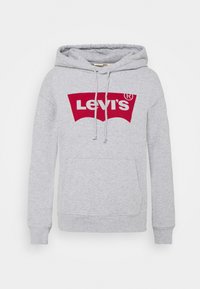 Felpa grigia realizzata in tessuto misto cotone. Presenta un logo rosso Levi's sul davanti, coulisse e una tasca a marsupio. Tessuto morbido.