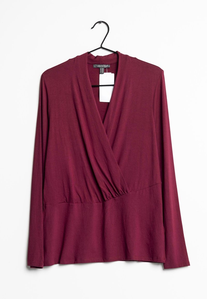 Burgundin pitkähihaisessa paidassa on kietaisusuunnittelu, V-pääntie ja kerätty vyötärö. Valmistettu pehmeästä, joustavasta kankaasta, roikkuu mustassa koukussa.