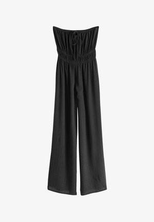 Čierny, široký overal vyrobený z ľahkého materiálu s elastickým, nariaseným živôtikom a nastaviteľnou šnúrkou pri výstrihu.