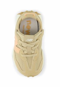 Beige New Balance sneaker in mesh and suede with lace-up front and peach accent on heel, shown from top view.