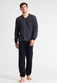 Navy checkered pajama set featuring a V-neck long-sleeve top and solid navy pants. Made from soft fabric with elastic cuffs at the wrists.