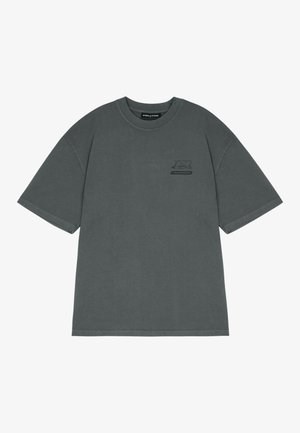 Gray cotton t-shirt with short sleeves, ribbed crew neck, and a small black logo accent on the left chest. Soft, matte texture.