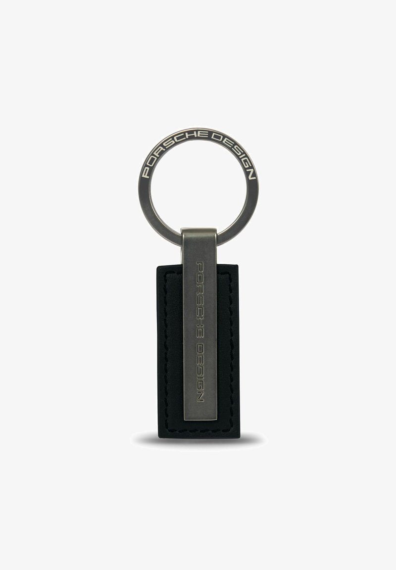 Portachiavi Porsche Design con anello metallico e linguetta in pelle nera rettangolare, decorata con il nome del marchio. Design elegante e moderno.