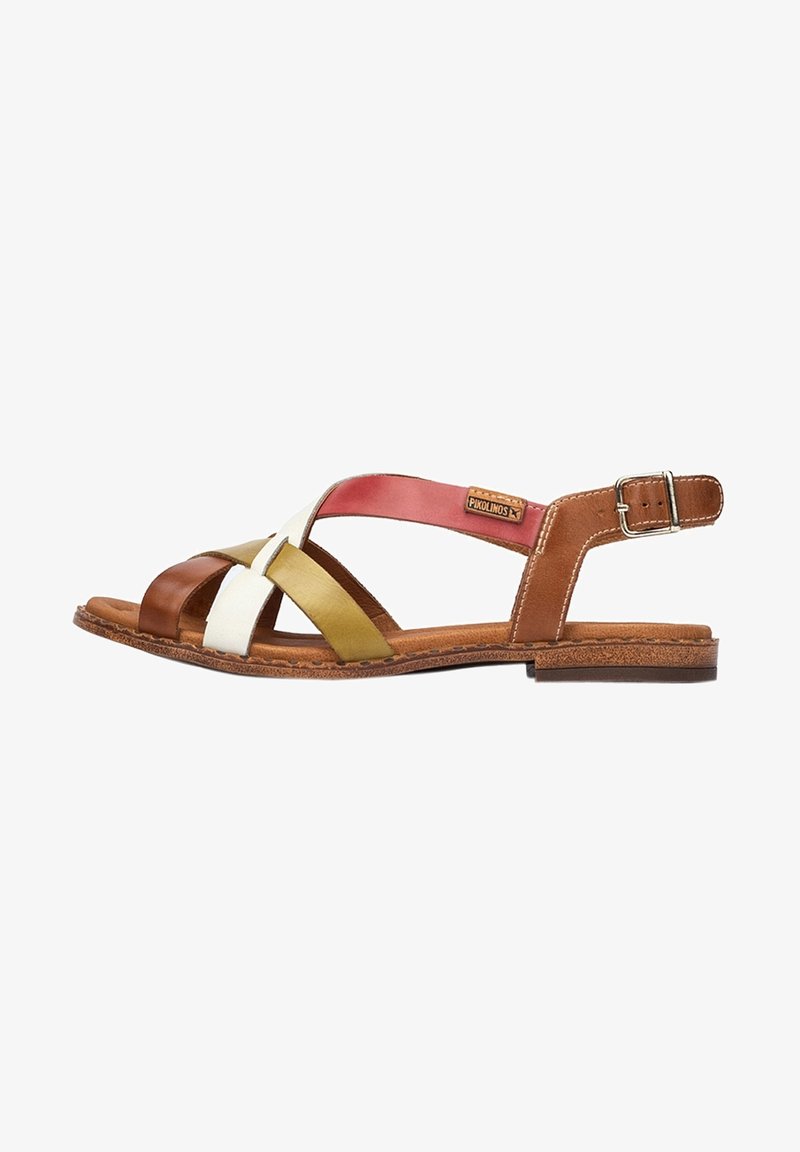 Brown, white, and olive green leather sandals with crisscross straps, adjustable ankle buckle, and a textured cork sole.