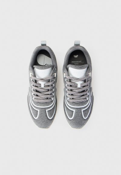 Gray fabric sneakers with white accents and laces, viewed from above, placed side by side on a white background.