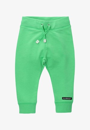 Green cotton joggers with a drawstring waist, ribbed cuffs, and small black logo label on the lower leg. Smooth texture and relaxed fit.