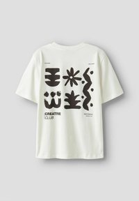 White cotton t-shirt featuring black abstract patterns and text. Round neckline, short sleeves, and relaxed fit.