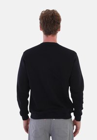 Schwarzer Rundhalsausschnitt-Sweatshirt aus Fleece, mit gerippten Bündchen und Saum, glatter Textur und lässiger Passform.