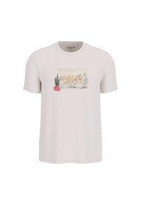 Camiseta de color beige claro con cuello redondo, con un estampado gráfico de la palabra "GUESS", cactus y acentos de flores. Mangas cortas.