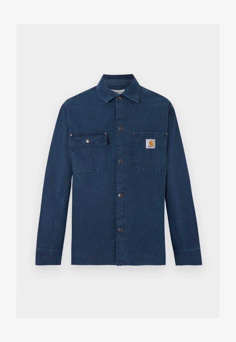 Marineblaues Cord-Arbeitshemd mit langen Ärmeln, Druckknopfverschluss vorne, zwei Brusttaschen und kleinem Carhartt-Logo auf der rechten Tasche.