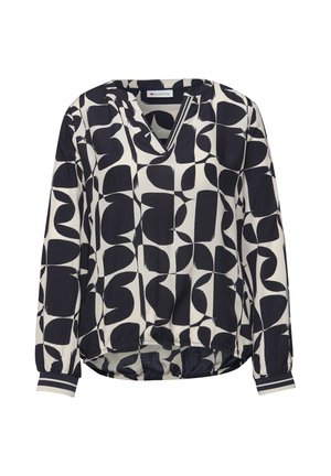 Blouse à manches longues avec motif géométrique abstrait noir et blanc, ourlet élastique et poignets rayés.